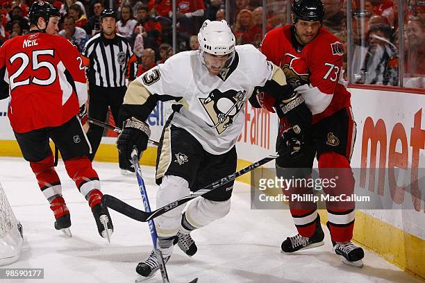 Alex Goligoski of the Pittsburgh Penguins battles for the puck with Jarkko Ruutu of the Ottawa Senators during Game 3 of the Eastern Conference...