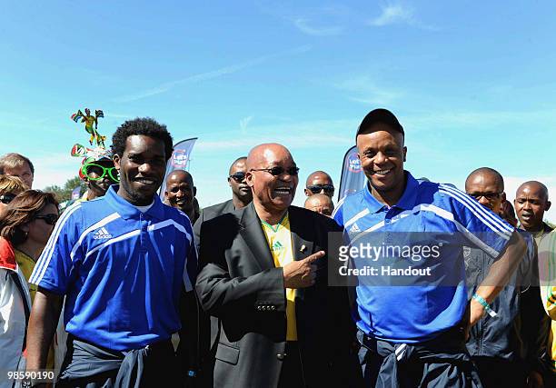 In this handout image provided by the 2010 FIFA World Cup Organising Committee South Africa, Jay-Jay Okocha, President Jacob Zuma and Doctor Khumalo...