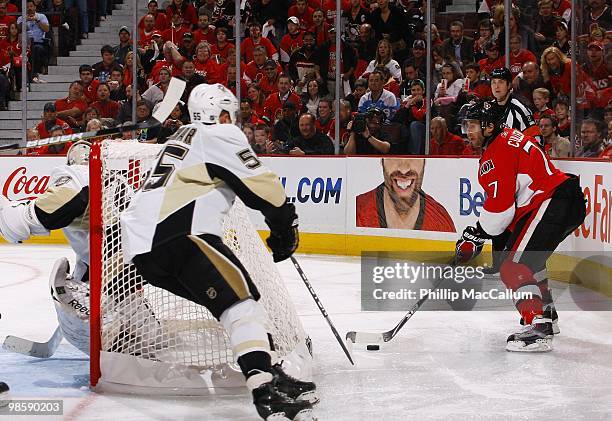 Matt Cullen of the Ottawa Senators looks to score on goaltender Marc-Andre Fleury of the Pittsburgh Penguins while Sergei Gonchar defends during Game...