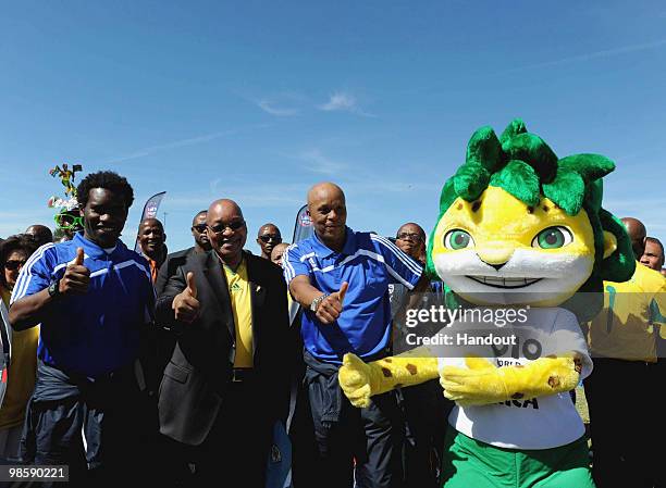 In this handout image provided by the 2010 FIFA World Cup Organising Committee South Africa, Jay-Jay Okocha, President Jacob Zuma and Doctor Khumalo...