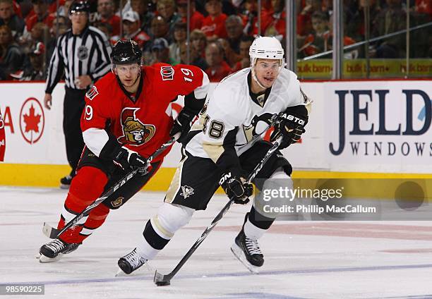 Tyler Kennedy of the Pittsburgh Penguins skates with the puck as he is pressured by Jason Spezza of the Ottawa Senators during Game 3 of the Eastern...