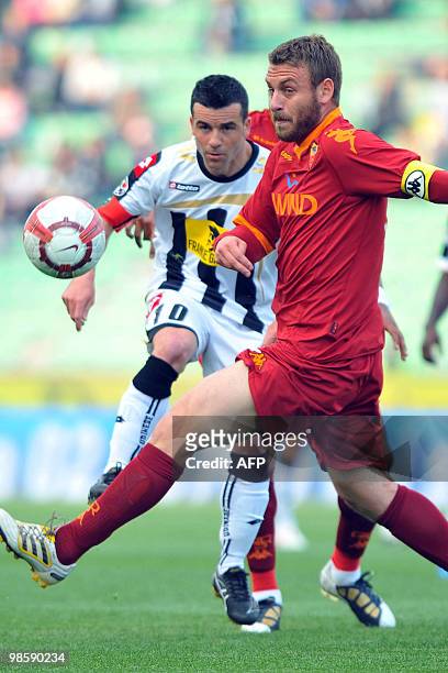 Roma's Daniele De Rossi vies with Udinese's Antonio Di Natale during their Coppa Italia semifinal match on April 21, 2010 in Udine. AS Roma coach...
