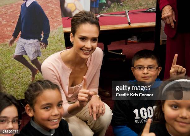 Jessica Alba poses with a group of children during a news conference to discuss the 1Goal campaign at the Rayburn House Office Building on April 21,...
