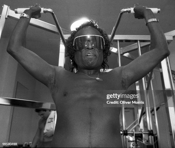 American jazz musician Miles Davis lifts weights, still in his sunglasses, in the health club atop the UN Plaza Hotel, New York, New York, mid 1980s.