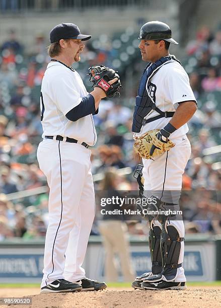 Phil Coke and Gerald Laird of the Detroit Tigers talk on the pitchers mound against the Cleveland Indians during the game at Comerica Park on April...