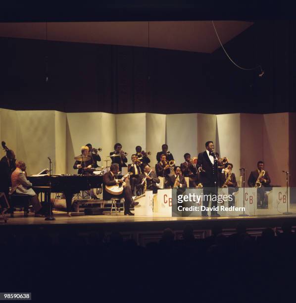 American jazz pianist and composer Count Basie performs live on stage with his orchestra and singer Joe Williams during a performance at the Carnegie...