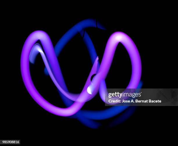 close-up abstract pattern of intertwined colorful light beams of color, blue and violet on a black background. - halo infinite stock pictures, royalty-free photos & images