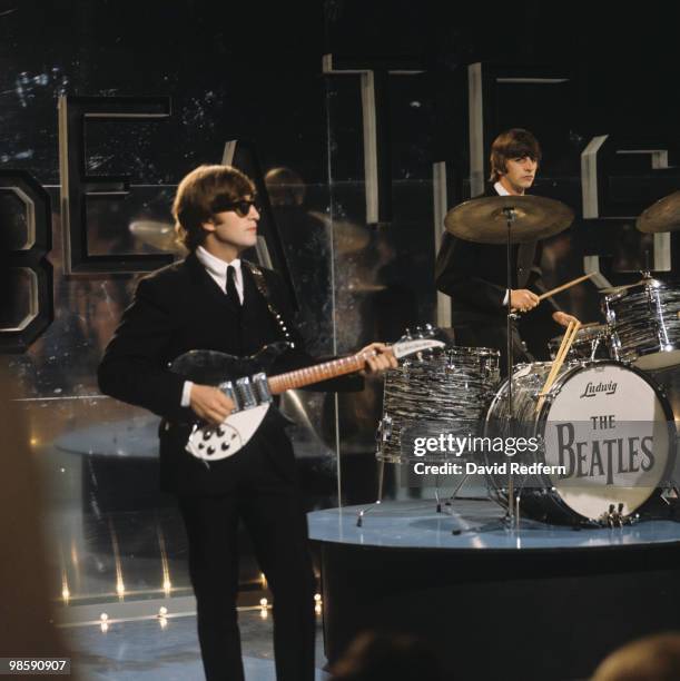From left, John Lennon and Ringo Starr of English rock and pop group The Beatles perform together on stage for the ABC Television music television...