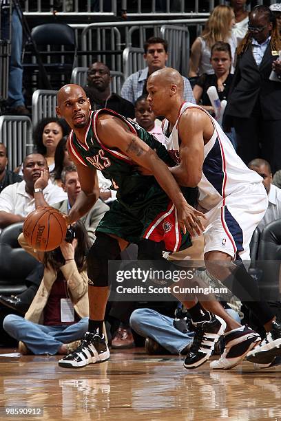 Jerry Stackhouse of the Milwaukee Bucks handles the ball against Maurice Evans of the Atlanta Hawks in Game Two of the Eastern Conference...