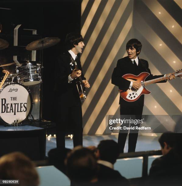 From left, Paul McCartney and George Harrison of English rock and pop group The Beatles perform together on stage for the ABC Television music...