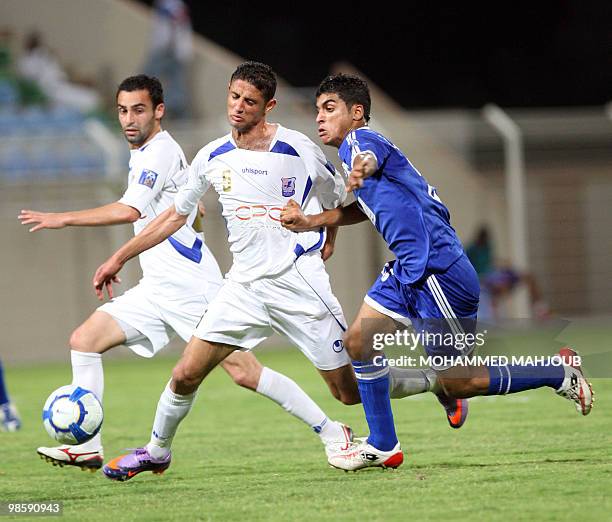 Syria's Al-Karamah player Abdel Fattah and Ahmad al-Omier fight for the ball with Mohammed al-Musalami of the Omani Saham club during their 2010 AFC...