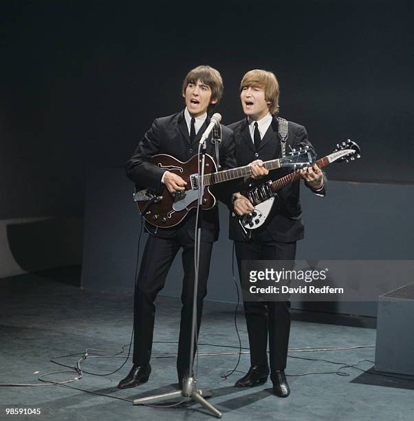 From left, George Harrison and John Lennon of English rock and pop group The Beatles perform together on stage for the American Broadcasting Company...
