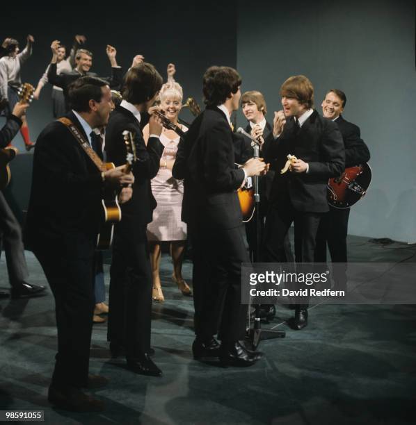 From left, John Lennon , Ringo Starr, Paul McCartney and George Harrison of English rock and pop group The Beatles on stage with members of the Karl...