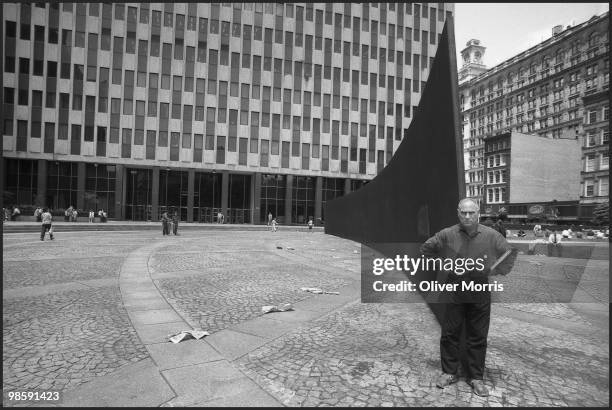 Portrait of American artist and sculptor Richard Serra as he poses with his massive steel sculpture 'Tilted Arc' in Federal Plaza, New York, New...