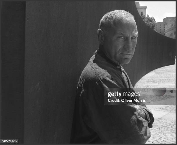 Portrait of American artist and sculptor Richard Serra as he poses with his massive steel sculpture 'Tilted Arc' in Federal Plaza, New York, New...