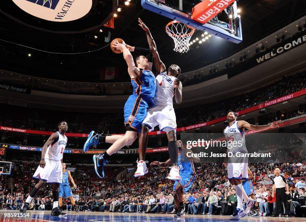 Nick Collison of the Oklahoma City Thunder drives to the basket for a layup against Samuel Dalembert of the Philadelphia 76ers during the game at...