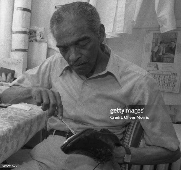 American tap dancer and actor Charles 'Honi' Coles tunes his tap shoes prior to a performance at the St. James Theater, New York, New York, 1984.