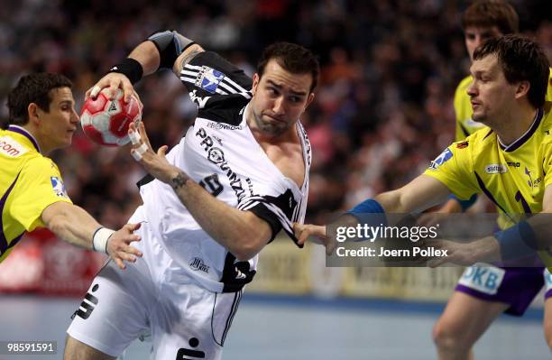 Igor Anic of Kiel battles for the ball with Bartlomiej Jaszka and Michal Kubisztal of Berlin during the Toyota Handball Bundesliga match between THW...