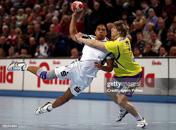 Daniel Narcisse of Kiel shoots at goal against Colja Loeffler of Berlin during the Toyota Handball Bundesliga match between THW Kiel and Fuechse...