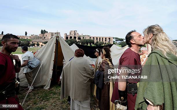 Man dressed up as an ancient Roman kisses a woman at Circo Massimo on April 21, 2010 in Rome, during a ceremony to celebrate the anniversary of the...