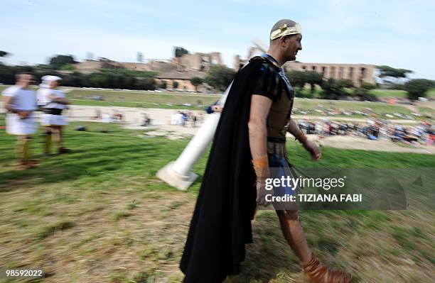 Man dressed up as an ancient Roman walks in front of the Rome's Circo Massimo on April 21 during a ceremony to celebrate the anniversary of the...