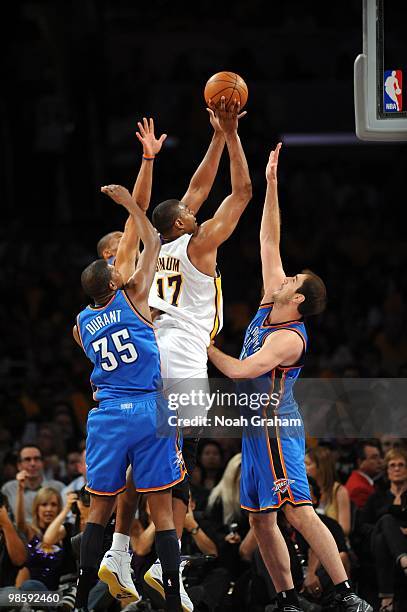 Andrew Bynum of the Los Angeles Lakers goes up for a shot against Kevin Durant, Nenad Krstic and Russell Westbrook of the Oklahoma City Thunder in...