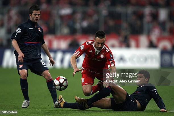 Diego Contento of Bayern is tackled by Ederson of Lyon while Miralem Pjanic of Lyon looks on during the UEFA Champions League semi final first leg...