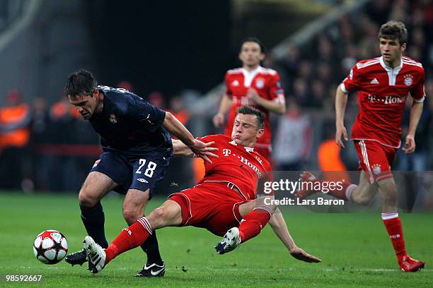 Jeremy Toulalan of Lyon is challenged by Ivica Olic of Bayern during the UEFA Champions League semi final first leg match between FC Bayern Muenchen...