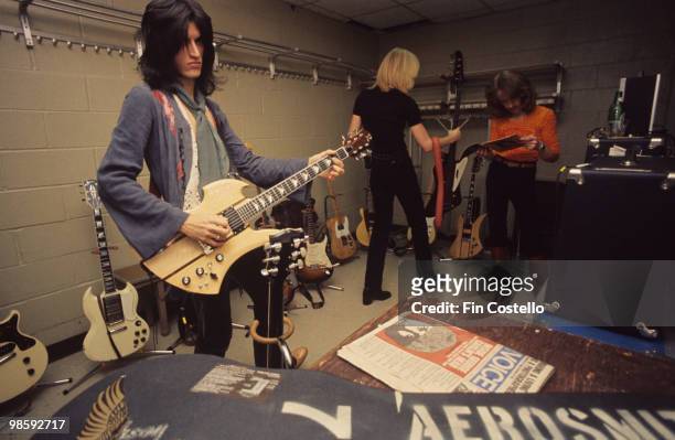 Guitarist Joe Perry, with a BC Rich Mockingbird guitar, Tom Hamilton and Joey Kramer of Aerosmith backstage at Madison Square Garden in New York City...