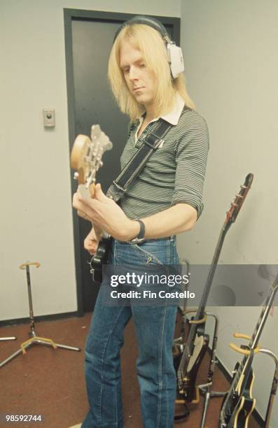 Bassist Tom Hamilton of Aerosmith plays backstage in 1976.