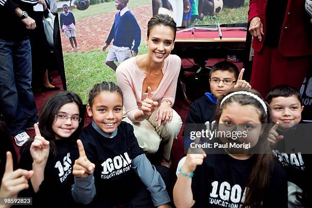 Jessica Alba poses with children at a news conference to discuss the 1Goal campaign at the Rayburn House Office Building on April 21, 2010 in...
