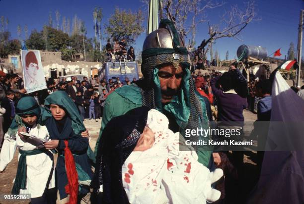 Men and children dressed as Imam Hussein's followers during Ta'zieh on The Day of Ashura in a village near Qom. Ta'zieh means Condolence Theater in...