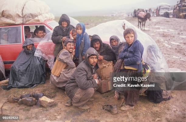 Kurdish family fleeing northern Iraq, wait in freezing cold, behind temporarily closed Iranian borders in Haji Omran region. Saddam Hussein crushed...