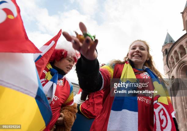 Carnival-goer of the wagon of the German soccer club 'FSV Mainz 05' throws sweets during the Rosenmontag carnival procession in Mainz, Germany, 12...