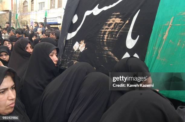 Group of women dressed in black chador carry a dummy coffin in south Tehran on The Day of Ashura which is on the 10th day of Muharram in the Islamic...