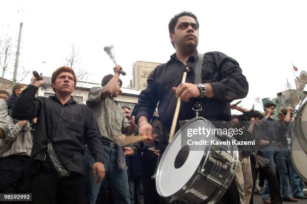 Men beat the drums, while others falagellate themselves with chains, during the mourning ceremony on The Day of Ashura in south Tehran. Ashura Day is...