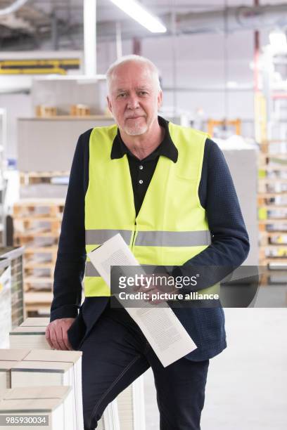 Thomas Ueberhoff, editor in chief at Rowohlt publishing house, holds a freshly printed text sheet of the book 'Feuer und Zorn. Im Weissen Haus von...