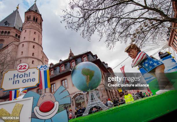 Political caricature float depicting US President Donald Trump hitting the Paris climate agreement with a golf club takes part in the Rosenmontag...