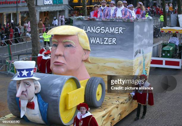 Caricature float featuring US President Donald Trump, is seen during the annual Rose Monday carnival procession in Cologne, Germany, 12 February...