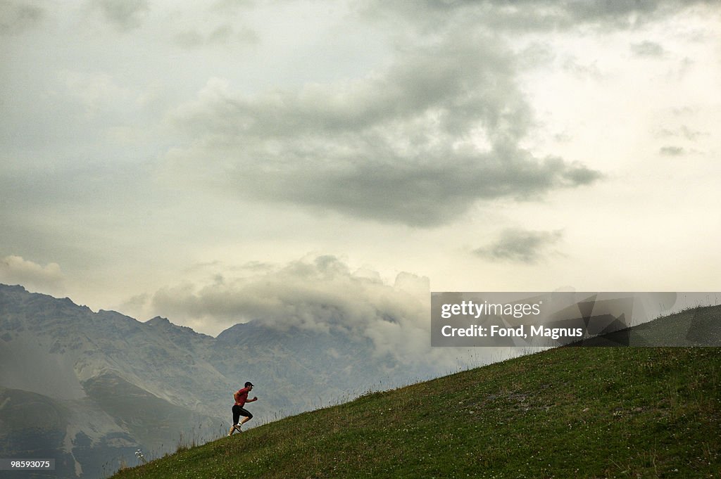 A man jogging in the mountains, Italy.