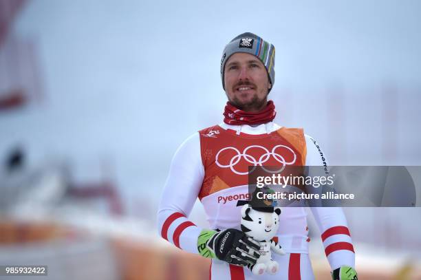 Winner Marcel Hirscher from Austria celebrates his performance at the men's combined slalom at Jeongseon Alpine Centre in Pyeongchnag, South Korea,...