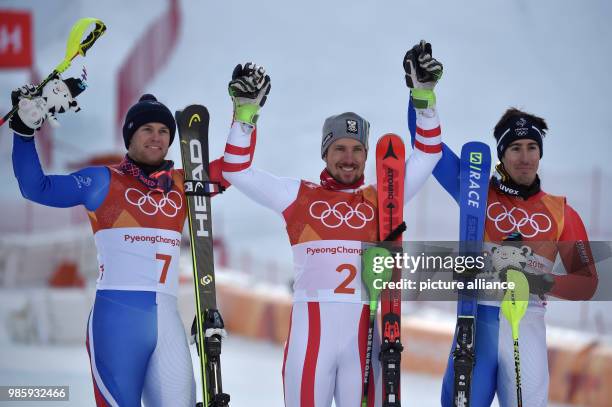 Winner Marcel Hirscher from Austria, runner-up Alexis Pinturault and second runner-up Victor Muffat-Jeandet from France celebrate their performances...