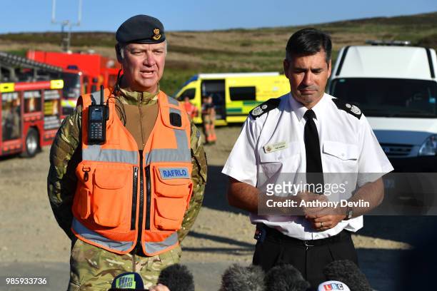 Wing Commander Gary Lane and GMFRS Assistant Chief Fire Officers Tony Hunter speak to media near Swineshaw reservoir in Stalybridge on June 28, 2018...