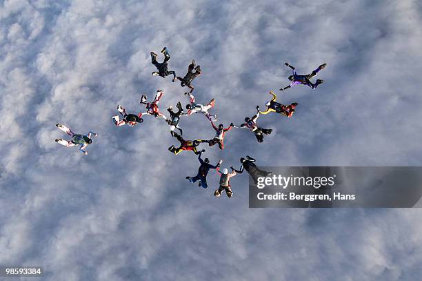 parachute jumpers in the sky, sweden. - aerial stunts flying stock pictures, royalty-free photos & images