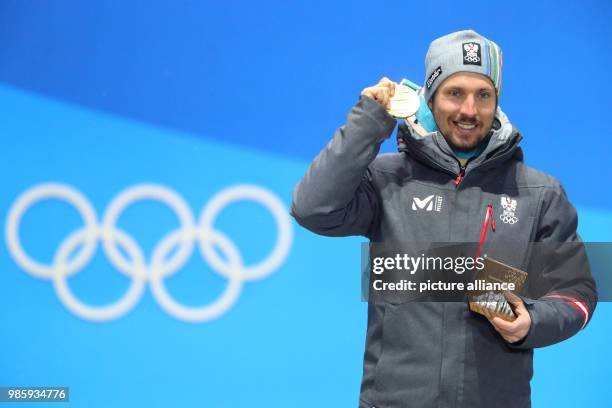 Alpine skier Marcel Hirscher from Austria celebrates winning a gold medal at the Winter Olympics in Pyeongchang, South Korea, 13 February 2018....