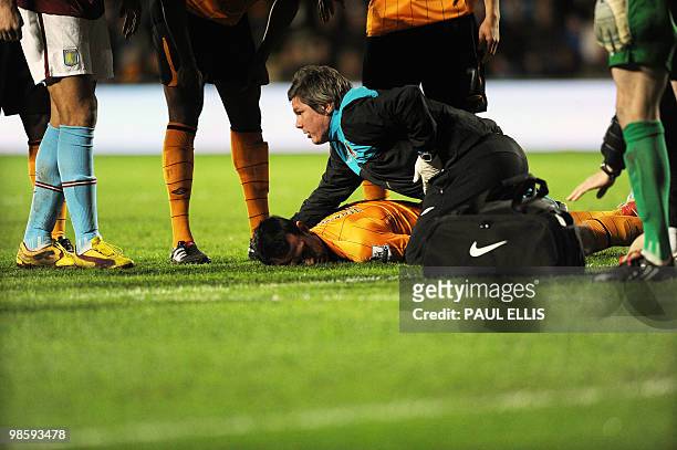 Hull City's Dutch forward Jan Vennegoor of Hesselink lies down on the field after colliding with Aston Villa's Richard Dunne during their English...
