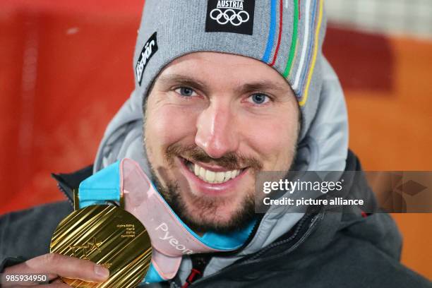 Alpine skier Marcel Hirscher from Austria celebrates winning a gold medal at the Winter Olympics in Pyeongchang, South Korea, 13 February 2018....