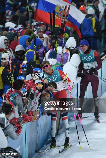 Norway's Johannes Hoesflot Klaebo takes pictures after coming in first at the men's cross-country skiing classic sprint at the Alpensia Centre in...