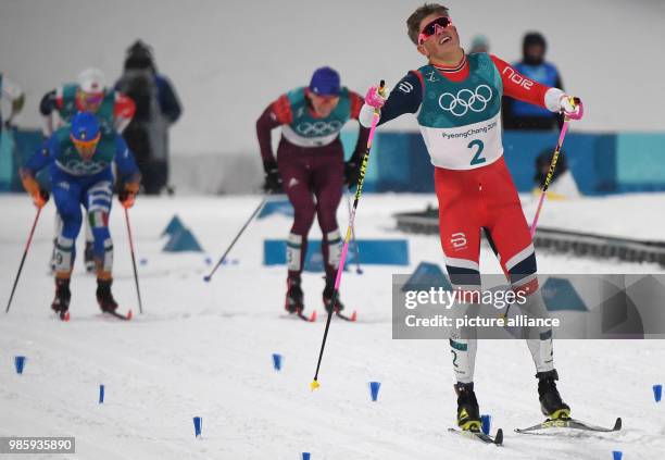 Johannes Hoesflot Klaebo from Norway celebrates his victory at the men's cross-country skiing classic sprint at the Alpensia Centre in Pyeongchang,...