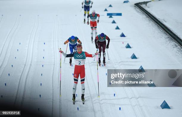 Norway's Johannes Hoesflot Klaebo crosses the finish line in front of Italy's Federico Pellegrino and Russia's Alexander Bolshunov at the men's...
